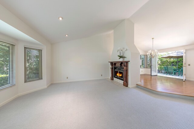 5150 Concord Pl, Carpinteria, CA 93013 - unfurnished living room with light carpet, a warm lit fireplace, a chandelier, lofted ceiling, and baseboards