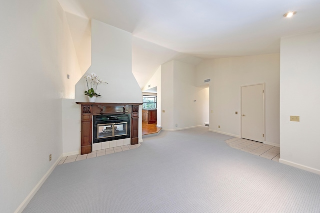 5150 Concord Pl, Carpinteria, CA 93013 - unfurnished living room featuring light carpet, vaulted ceiling, baseboards, and a tiled fireplace