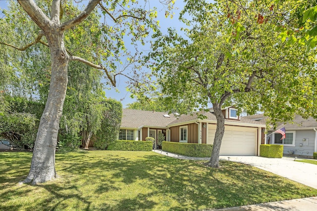 5150 Concord Pl, Carpinteria, CA 93013 - single story home with a garage, driveway, a front yard, board and batten siding, and a shingled roof