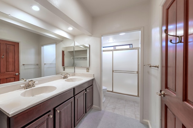 5150 Concord Pl, Carpinteria, CA 93013 - bathroom featuring toilet, double vanity, a shower stall, recessed lighting, and tile patterned floors