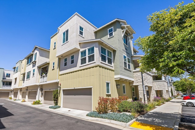 5696 Surfrider Way Unit 101, Goleta, CA 93117 - view of front of house featuring a garage and stone siding