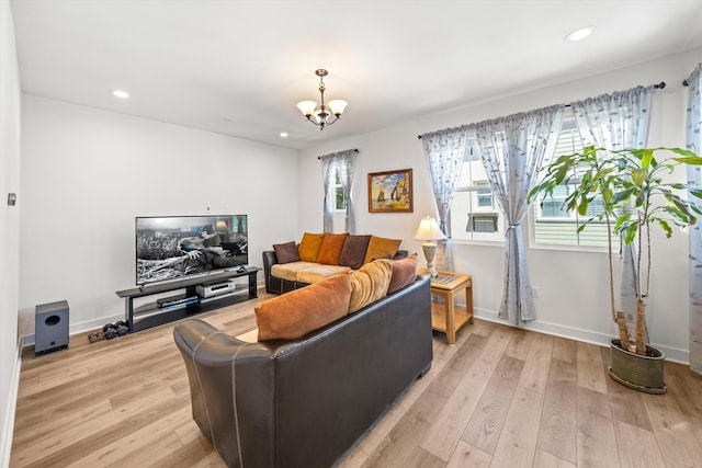 5696 Surfrider Way Unit 101, Goleta, CA 93117 - living area featuring a chandelier, recessed lighting, light wood-style floors, and baseboards