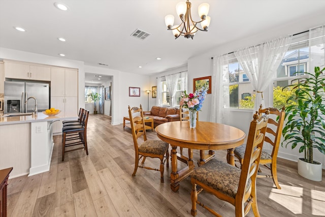5696 Surfrider Way Unit 101, Goleta, CA 93117 - dining area with light wood-style floors, recessed lighting, baseboards, and a chandelier