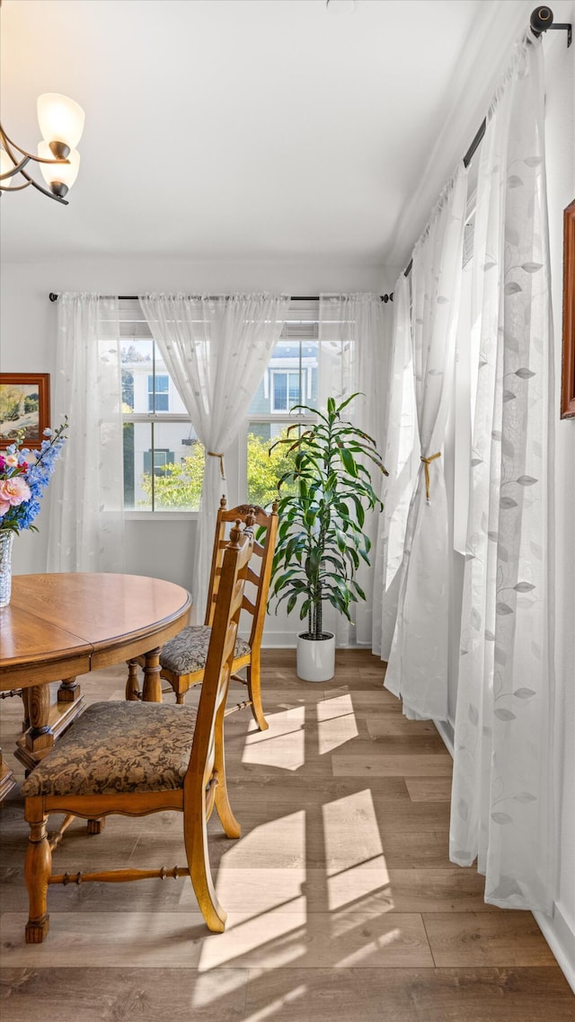 5696 Surfrider Way Unit 101, Goleta, CA 93117 - dining space featuring wood finished floors and a chandelier