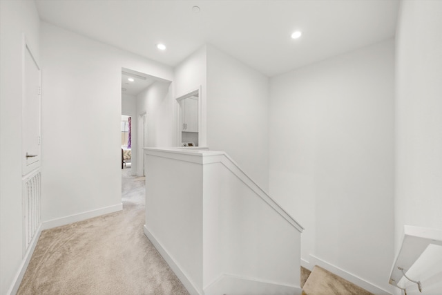 5696 Surfrider Way Unit 101, Goleta, CA 93117 - hallway featuring an upstairs landing, recessed lighting, light colored carpet, and baseboards