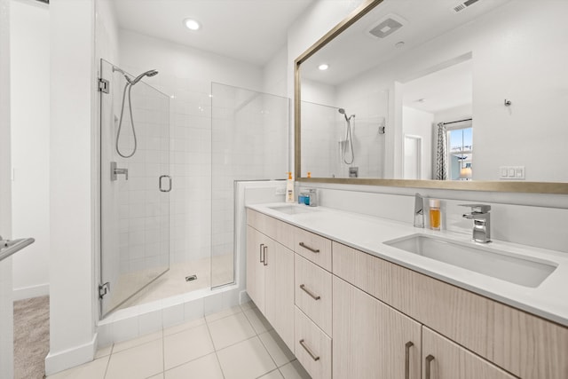 5696 Surfrider Way Unit 101, Goleta, CA 93117 - bathroom featuring a stall shower, recessed lighting, double vanity, and tile patterned floors