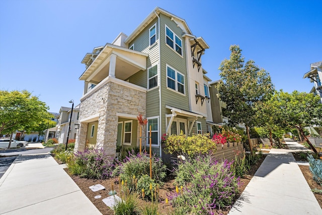 5696 Surfrider Way Unit 101, Goleta, CA 93117 - view of side of home with stone siding
