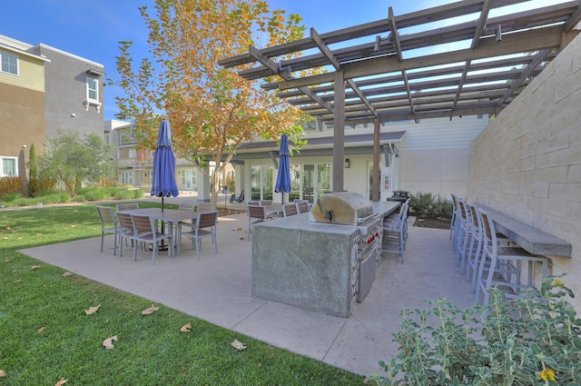 5696 Surfrider Way Unit 101, Goleta, CA 93117 - view of patio / terrace with a pergola and exterior kitchen