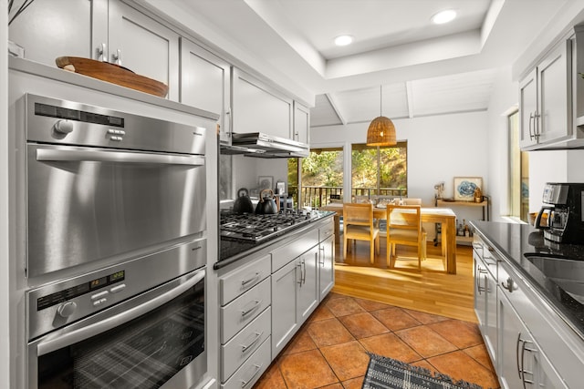 2648 State St Unit 32, Santa Barbara, CA 93105 - kitchen with appliances with stainless steel finishes, light tile patterned floors, recessed lighting, pendant lighting, and dark stone countertops
