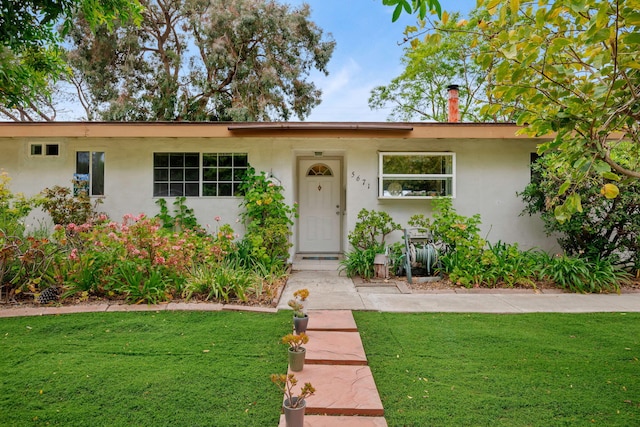 5671 Cathedral Oaks Rd, Goleta, CA 93117 - ranch-style home with a front lawn and stucco siding