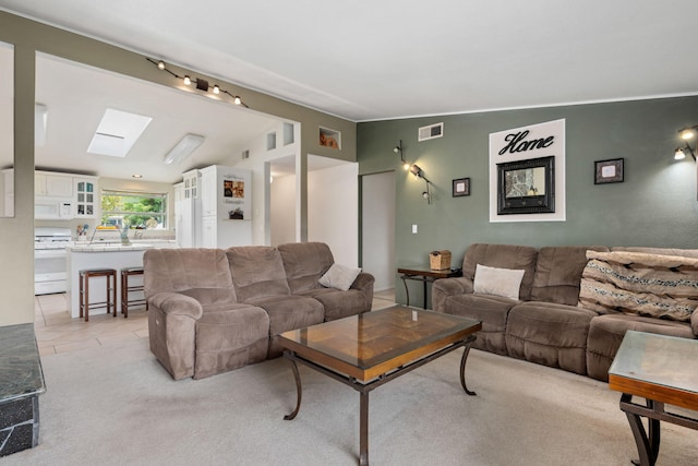5671 Cathedral Oaks Rd, Goleta, CA 93117 - living room featuring a skylight, light carpet, and lofted ceiling