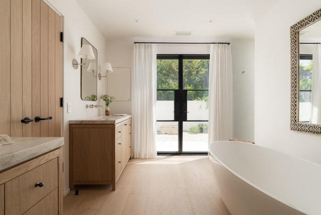 99 Sierra Vista Rd, Santa Barbara, CA 93108 - bathroom with vanity, a freestanding bath, plenty of natural light, and wood finished floors