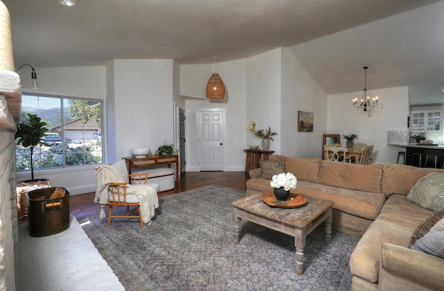 227 Menlo Dr, Buellton, CA 93427 - living room with a chandelier, wood finished floors, baseboards, and high vaulted ceiling