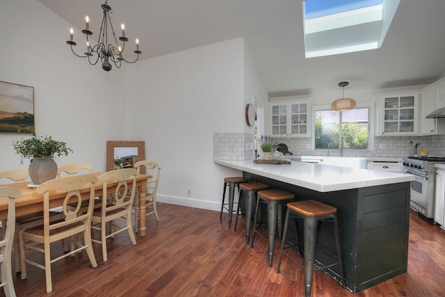 227 Menlo Dr, Buellton, CA 93427 - kitchen with high end range, tasteful backsplash, white cabinetry, a chandelier, and a sink
