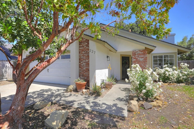 227 Menlo Dr, Buellton, CA 93427 - view of front of home with stucco siding, brick siding, and a garage