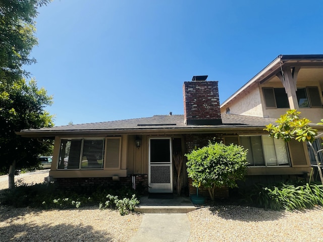 459 Linfield Pl, Goleta, CA 93117 - view of front of home featuring a chimney, roof with shingles, and board and batten siding