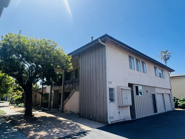 459 Linfield Pl, Goleta, CA 93117 - view of front of property featuring a garage, stairway, stucco siding, and asphalt driveway