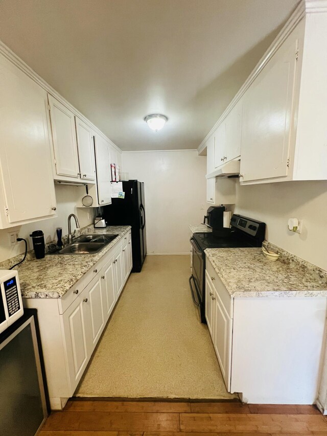 459 Linfield Pl, Goleta, CA 93117 - kitchen featuring stainless steel electric stove, a sink, under cabinet range hood, and white cabinetry