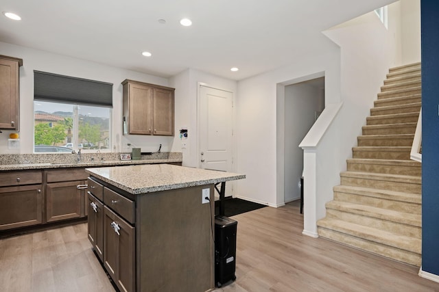 1926 Pump House Ln, Santa Paula, CA 93060 - kitchen featuring a sink, light wood-type flooring, recessed lighting, light stone countertops, and a kitchen island