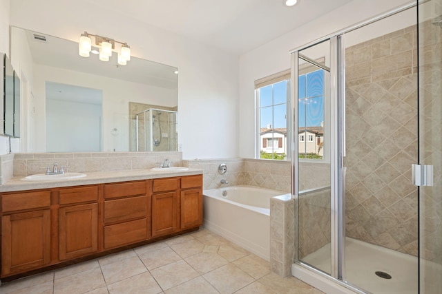 598 Poppyfield Pl, Goleta, CA 93117 - full bath featuring tile patterned flooring, a shower stall, a bath, double vanity, and recessed lighting