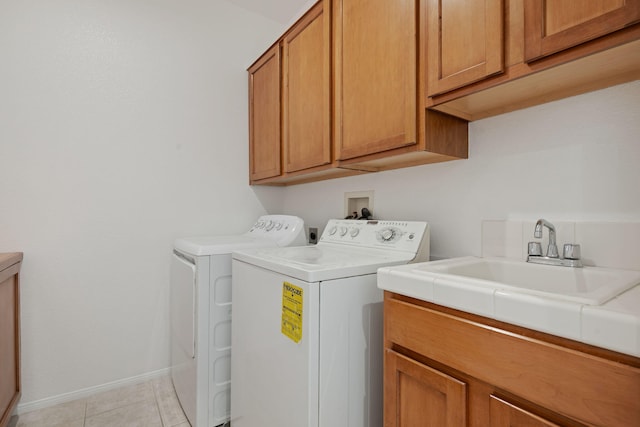 598 Poppyfield Pl, Goleta, CA 93117 - washroom featuring cabinet space, washer and clothes dryer, baseboards, and light tile patterned flooring