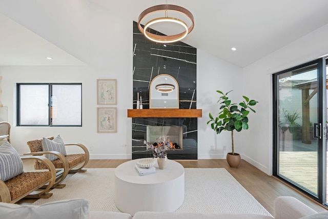 7352 Elmhurst Pl, Goleta, CA 93117 - living room featuring wood finished floors, baseboards, recessed lighting, lofted ceiling, and a fireplace