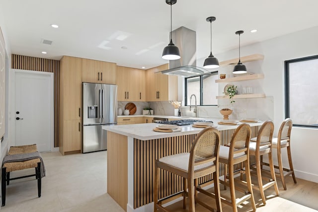 7352 Elmhurst Pl, Goleta, CA 93117 - kitchen featuring stainless steel appliances, light brown cabinets, light countertops, tasteful backsplash, and a sink