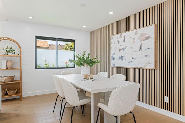 7352 Elmhurst Pl, Goleta, CA 93117 - dining space featuring an accent wall, recessed lighting, baseboards, and light wood finished floors