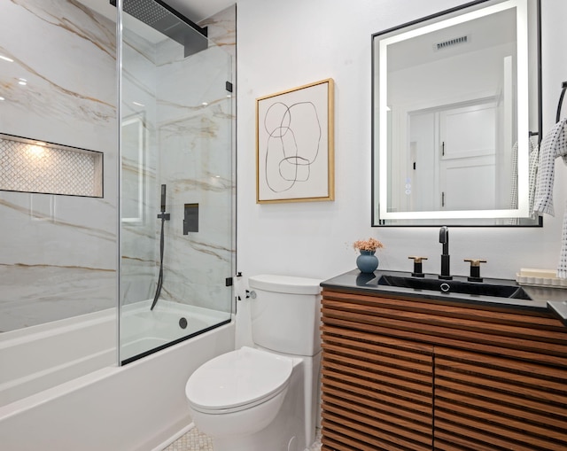 7352 Elmhurst Pl, Goleta, CA 93117 - bathroom featuring toilet, vanity, and shower / bath combination with glass door