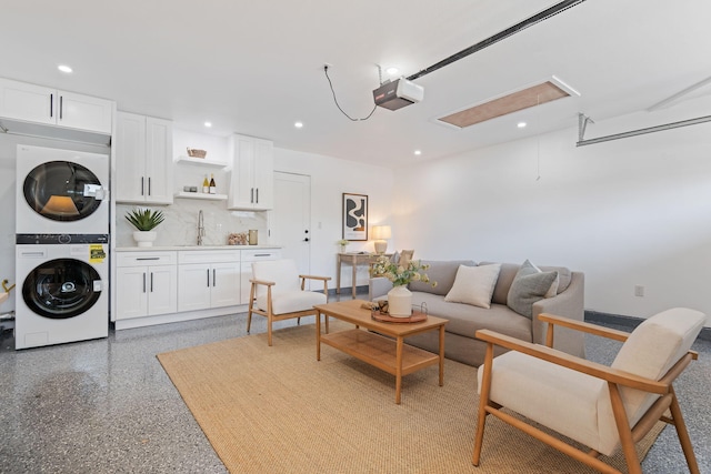 7352 Elmhurst Pl, Goleta, CA 93117 - living area featuring stacked washer / drying machine, recessed lighting, wet bar, dark speckled floor, and attic access