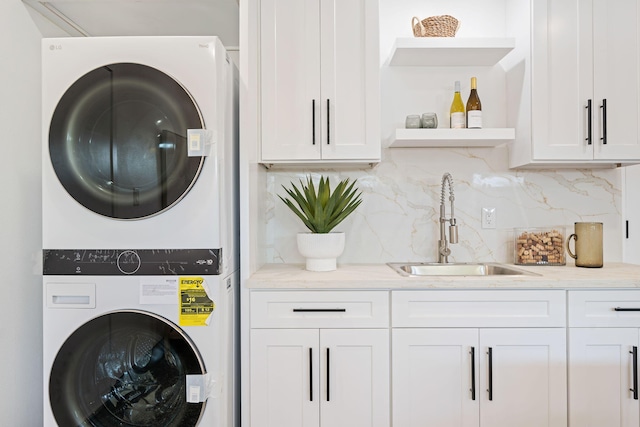 7352 Elmhurst Pl, Goleta, CA 93117 - laundry room with stacked washer / dryer, cabinet space, and bar area