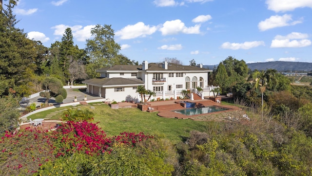 5287 N Creston Ln, Somis, CA 93066 - rear view of house with a yard, an outdoor pool, a garage, and a chimney
