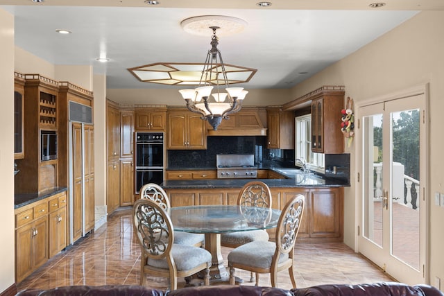 5287 N Creston Ln, Somis, CA 93066 - kitchen featuring a sink, dark countertops, decorative backsplash, brown cabinetry, and custom range hood