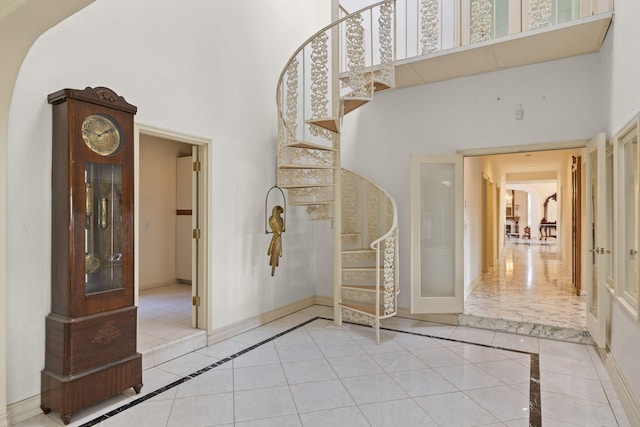 5287 N Creston Ln, Somis, CA 93066 - entryway featuring inlaid floor details, a towering ceiling, stairs, baseboards, and tile patterned flooring