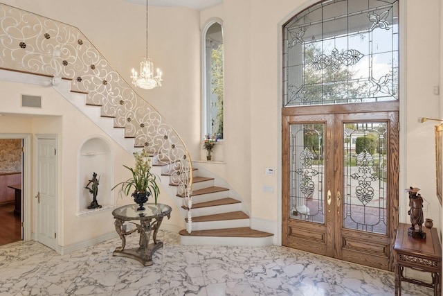 5287 N Creston Ln, Somis, CA 93066 - foyer with stairs, marble look tiles, a chandelier, a towering ceiling, and french doors