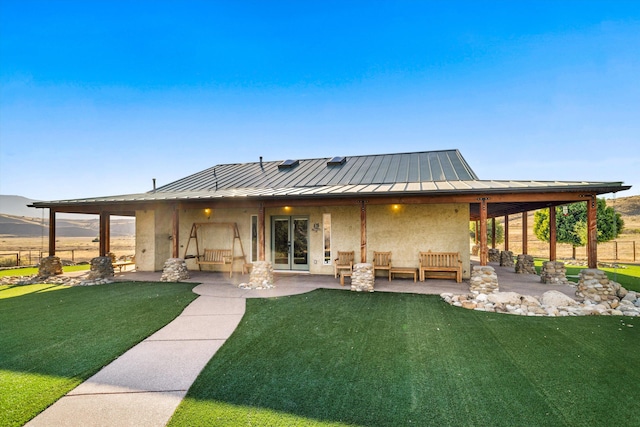 13750 Cuyama Hwy, Cuyama, CA 93461 - rear view of property with a standing seam roof, stucco siding, a patio, and metal roof
