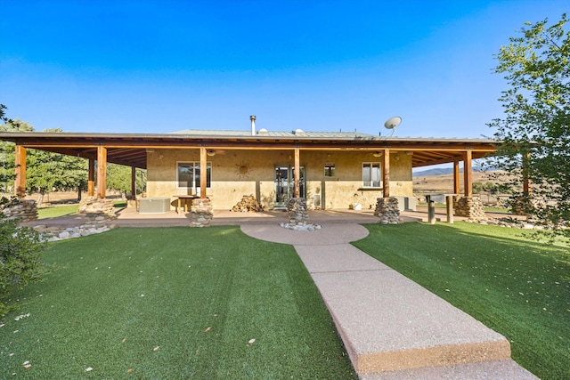 13750 Cuyama Hwy, Cuyama, CA 93461 - back of property featuring a patio area, stucco siding, and a yard