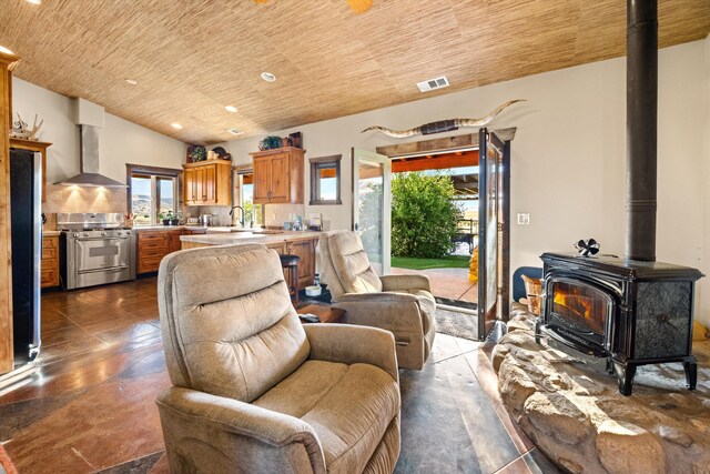 13750 Cuyama Hwy, Cuyama, CA 93461 - living area featuring a wood stove, wood ceiling, and recessed lighting