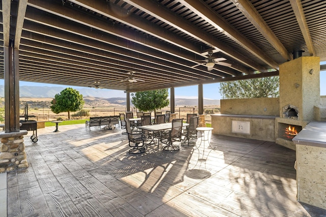 13750 Cuyama Hwy, Cuyama, CA 93461 - view of patio / terrace featuring ceiling fan, outdoor dining area, a mountain view, and exterior kitchen