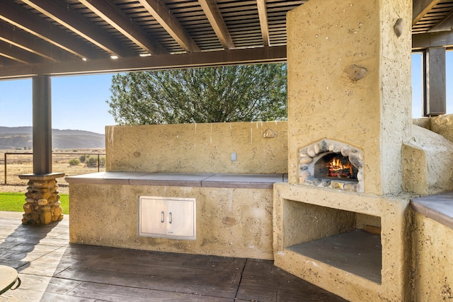 13750 Cuyama Hwy, Cuyama, CA 93461 - view of patio / terrace featuring exterior kitchen, a warm lit fireplace, and a deck with mountain view