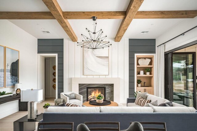 123 Polo Way, Santa Barbara, CA 93013 - living room featuring a chandelier, beamed ceiling, wood finished floors, a high end fireplace, and built in shelves