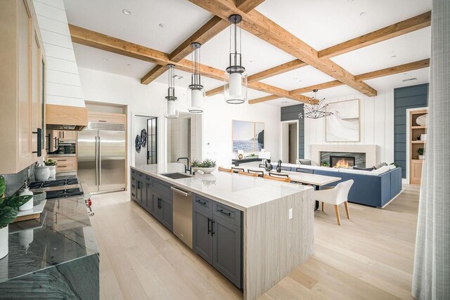 123 Polo Way, Santa Barbara, CA 93013 - kitchen with stainless steel appliances, open floor plan, coffered ceiling, gray cabinets, and light wood-style floors