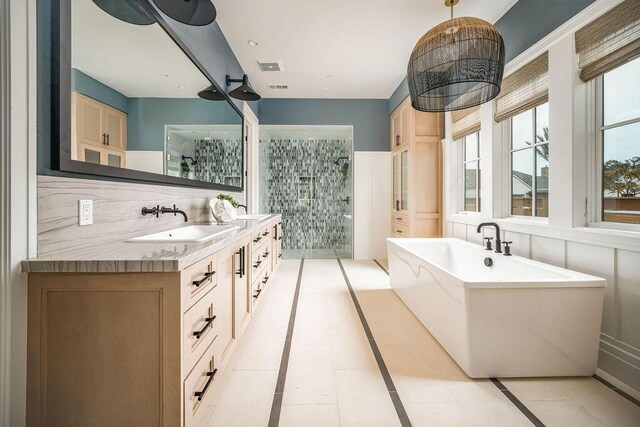 123 Polo Way, Santa Barbara, CA 93013 - full bathroom featuring a shower stall, a freestanding bath, double vanity, and inlaid floor details