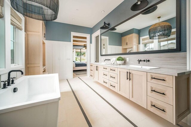 123 Polo Way, Santa Barbara, CA 93013 - full bathroom with double vanity, wainscoting, backsplash, connected bathroom, and tile patterned floors