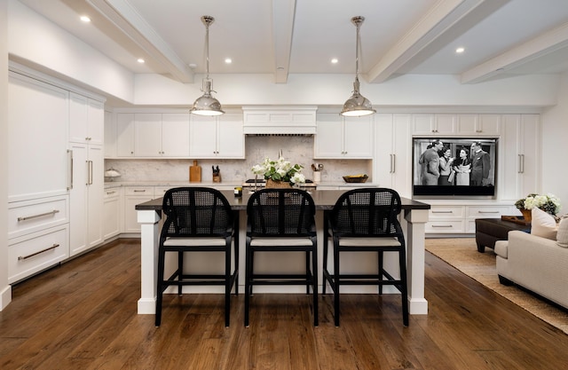 1479 Bonnymede Dr, Santa Barbara, CA 93108 - kitchen featuring beamed ceiling, decorative backsplash, white cabinetry, dark wood-type flooring, and a kitchen breakfast bar