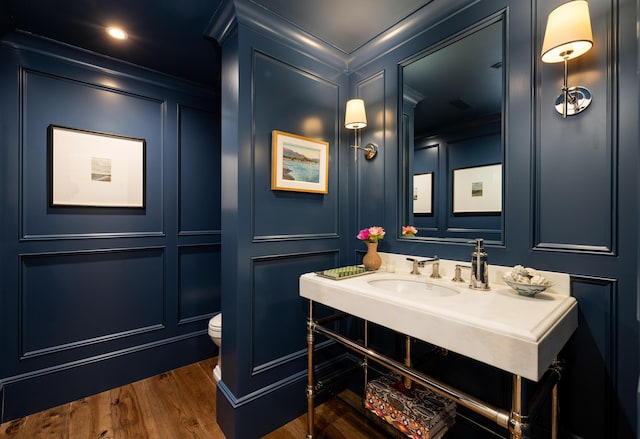 1479 Bonnymede Dr, Santa Barbara, CA 93108 - half bathroom with a decorative wall, crown molding, toilet, wood finished floors, and vanity