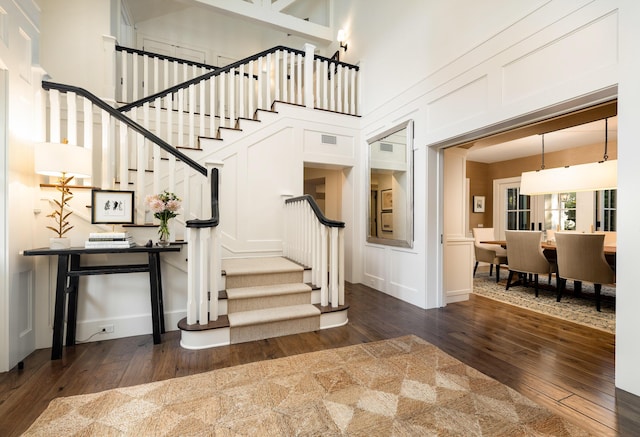 1479 Bonnymede Dr, Santa Barbara, CA 93108 - foyer with dark wood finished floors, stairs, a towering ceiling, and baseboards