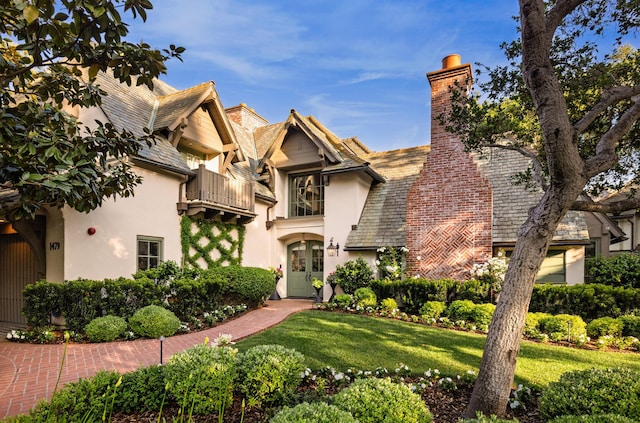 1479 Bonnymede Dr, Santa Barbara, CA 93108 - view of front of property with a balcony, stucco siding, a chimney, and a front lawn