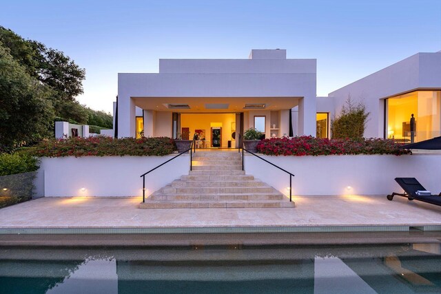 356 Woodley Rd, Montecito, CA 93108 - back of property at dusk featuring stairs and stucco siding