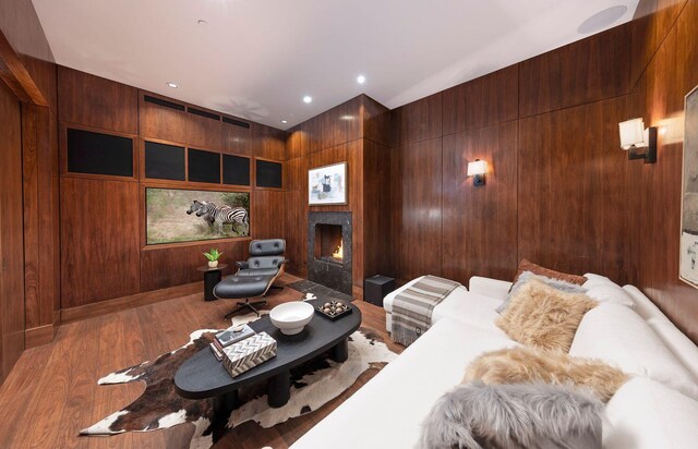 356 Woodley Rd, Montecito, CA 93108 - living room featuring a fireplace with flush hearth, wood walls, and wood finished floors